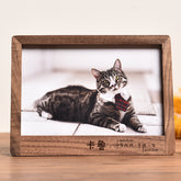 Wooden photo frame with a cat inside, featuring a wooden border.