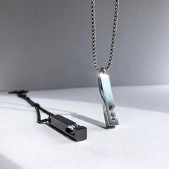 Two unique necklaces on a light surface with a neutral background