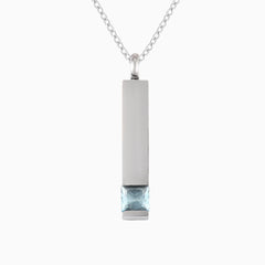Silver necklace with a rectangular pendant featuring a blue gemstone on a white background