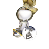Keychain with a cat charm and bell on a white background