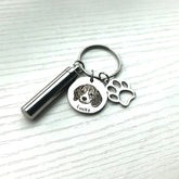 Keychain with pet urn and engraved tag on a white background