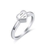 Silver ring with a heart-shaped engraved nameplate on a white background