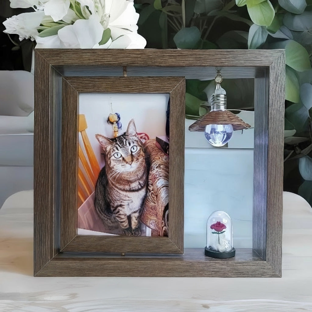 Wooden picture frame with a cat photo and small decorative item on a surface.