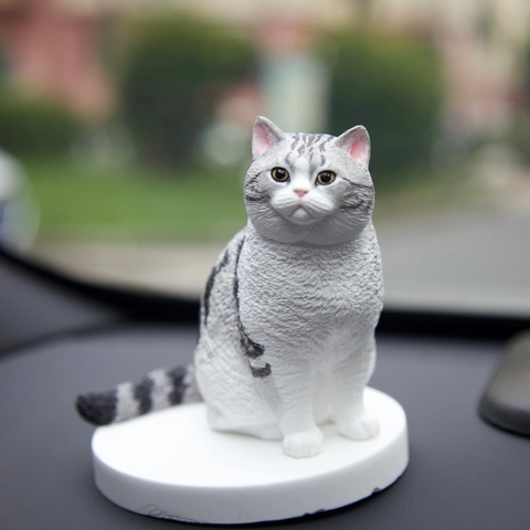 Cat-shaped decorative figure on a blurred outdoor background