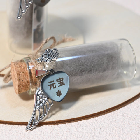 Glass bottle with cork stopper containing charms including a heart-shaped tag with Chinese characters, a wing charm, and a handprint charm.