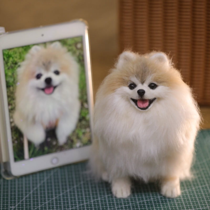 Small dog next to a tablet displaying an image of another dog