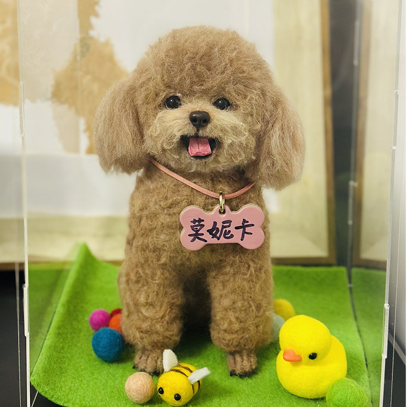 Small brown dog with a pink collar and tag, standing on a green surface with toys around.