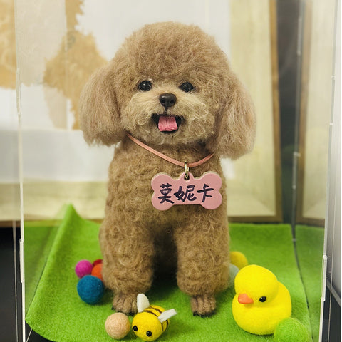 Small brown dog with a pink collar and tag, standing on a green surface with toys around.