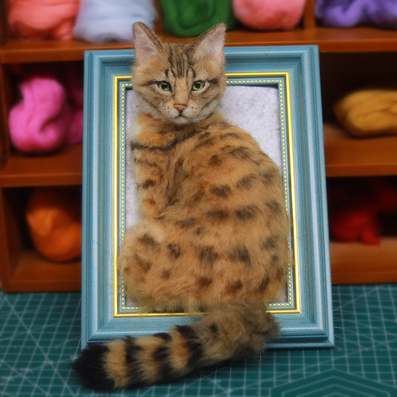 Cat sitting inside a decorative frame with colorful yarn balls in the background