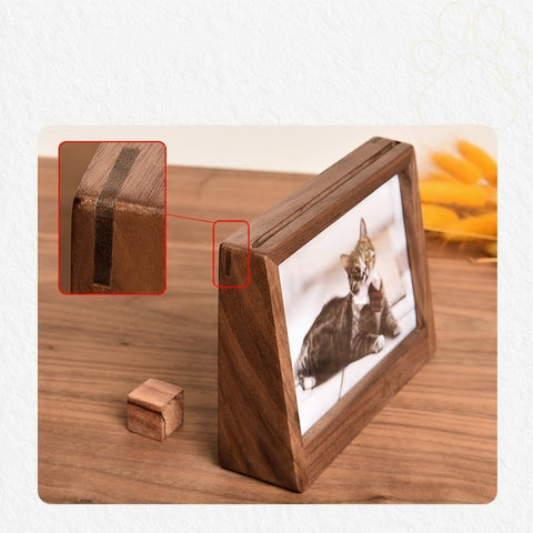 Wooden photo frame with a corner detail on a wooden surface