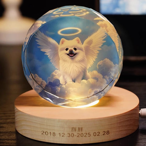Glass ball with a dog angel design on a wooden base