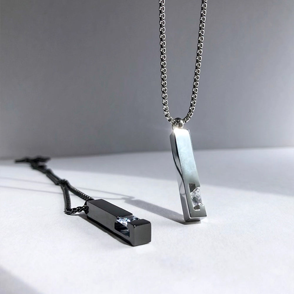 Two unique necklaces on a light surface with a neutral background