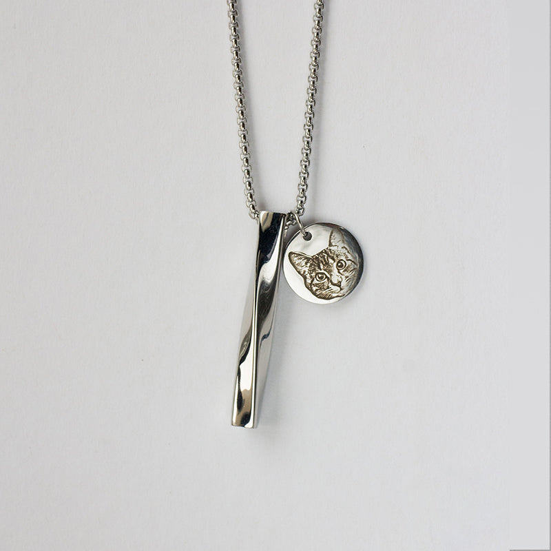 Silver necklace with a unique pendant on a light gray background
