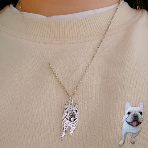 Necklace with a dog pendant on a beige sweater, with an inset of a white dog.