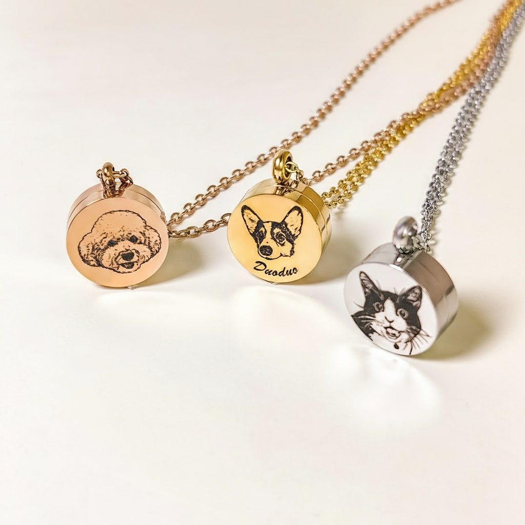 Three pet portrait necklaces on a light background