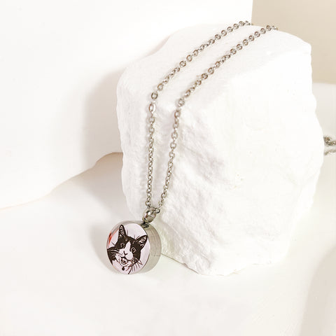Necklace with a pendant featuring a cat's face on a white cushion