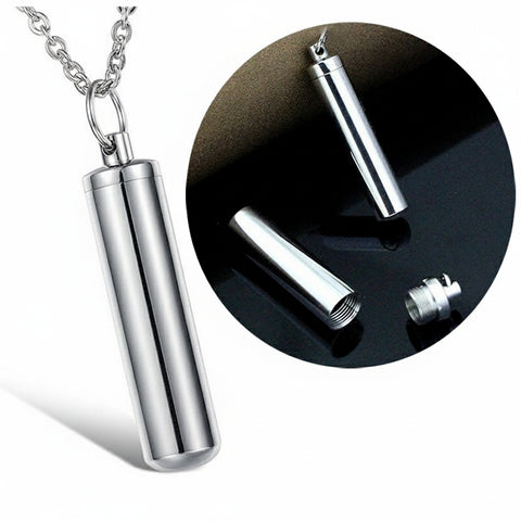 Silver cylindrical pendant on a chain with close-up inset on a black background