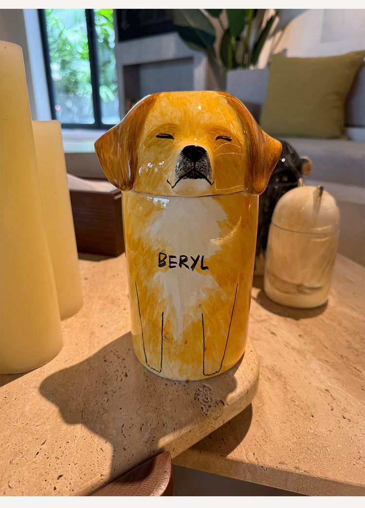 Dog-shaped candle with 'BERYL' on a surface indoors