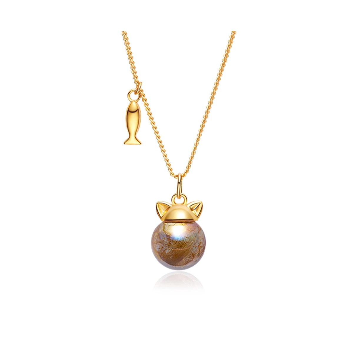 Gold necklace with a round pendant and fish charm on a white background