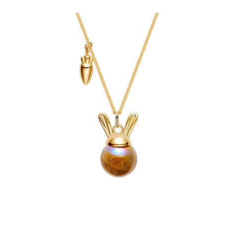 Gold necklace with a round pendant and bunny ears on a white background