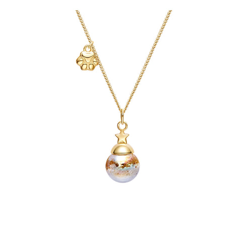 Gold necklace with a decorative pendant on a white background