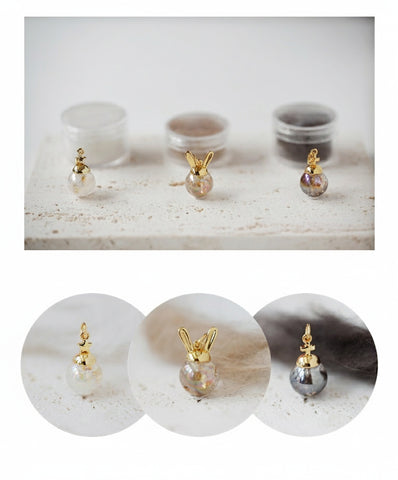Gold and pearl earrings displayed on a marble surface with close-up insets.