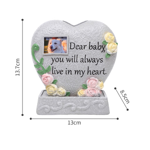 Heart-shaped memorial with floral designs and a photo frame, featuring text 'Dear baby you will always live in my heart.'