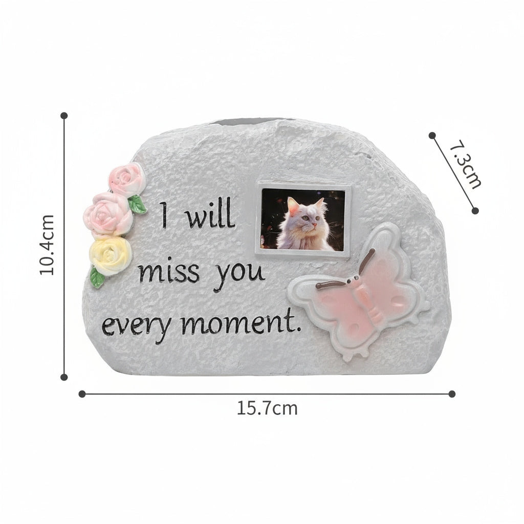 Memorial stone with floral design, butterfly, and photo of a cat with text 'I will miss you every moment.'