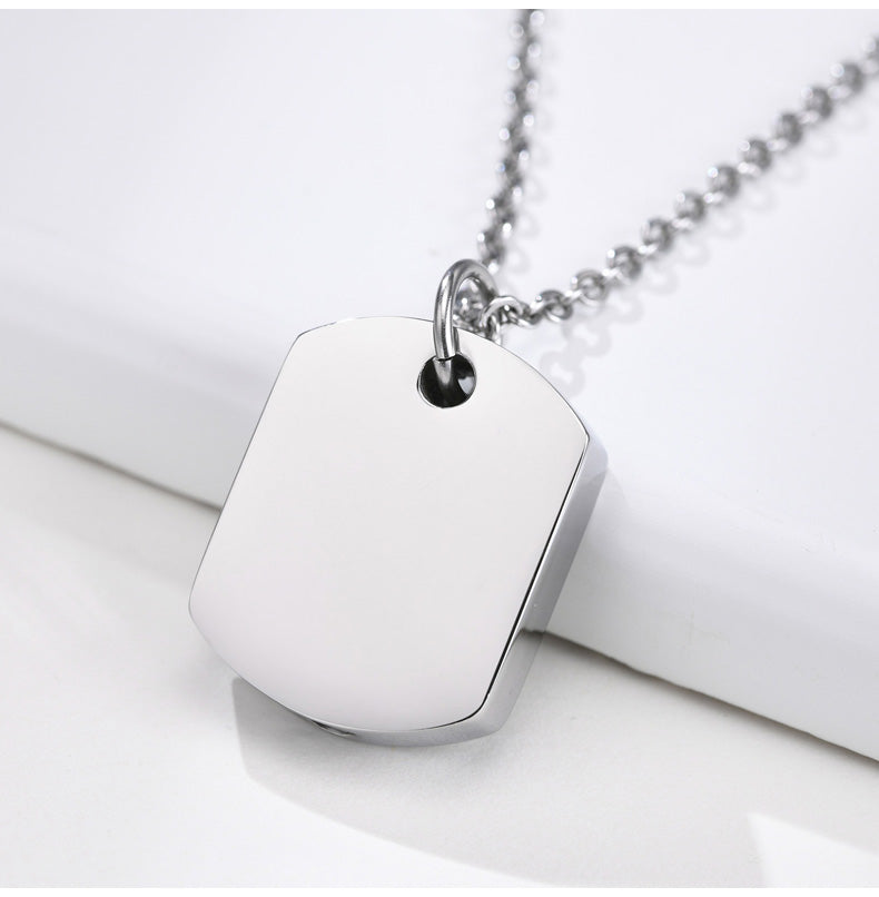Silver pendant necklace on a white surface