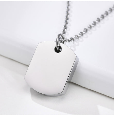 Silver pendant necklace on a white surface