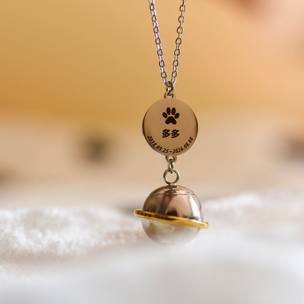 Necklace with a paw print pendant and engraved text on a soft background
