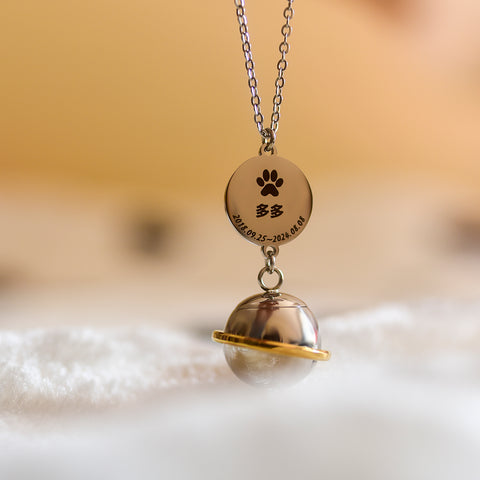 Necklace with a paw print pendant and engraved text on a soft background