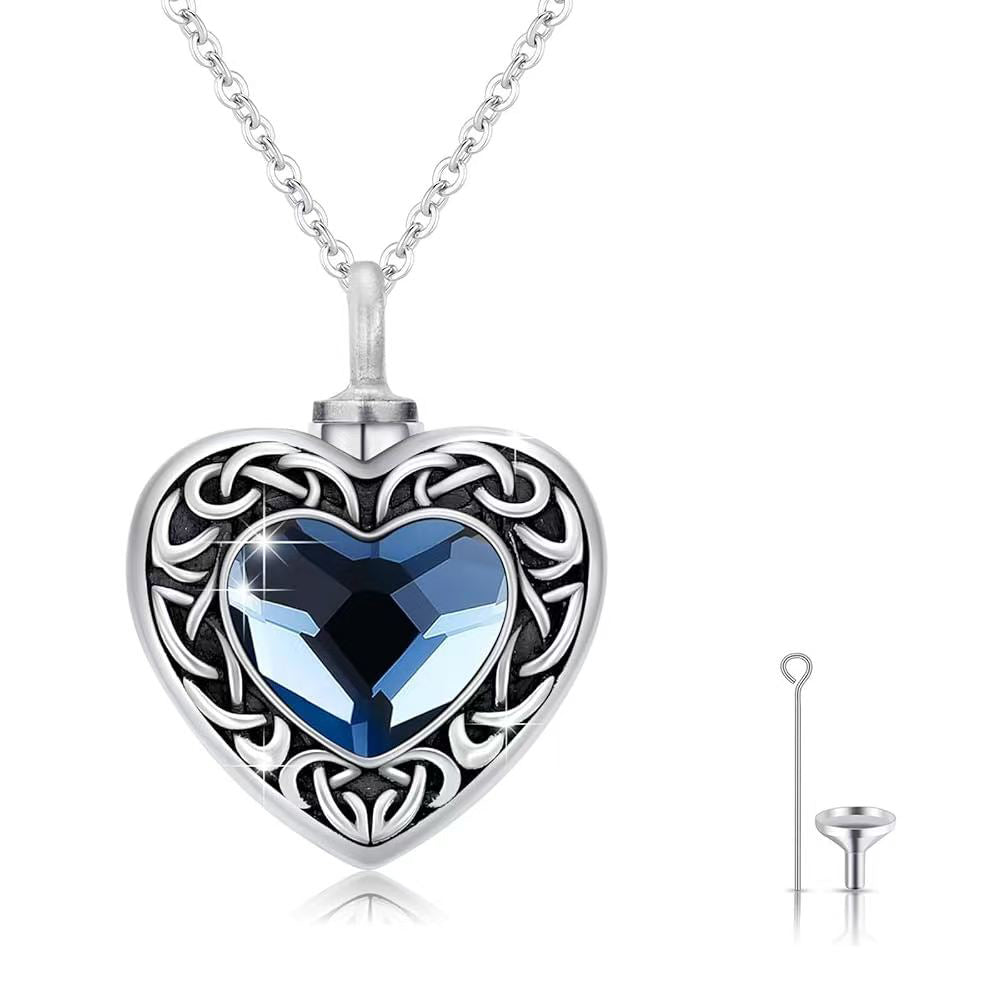 Heart-shaped necklace with blue gemstone and silver chain on a white background