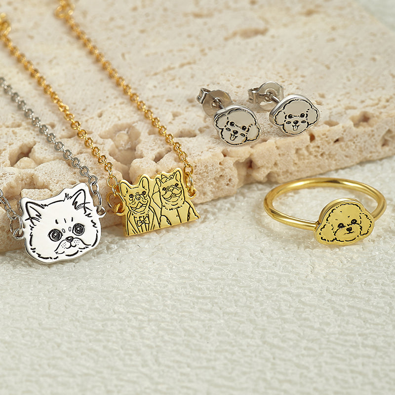 Jewelry set with dog-themed pendants on a textured surface