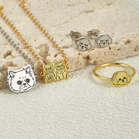 Jewelry set with dog-themed pendants on a textured surface