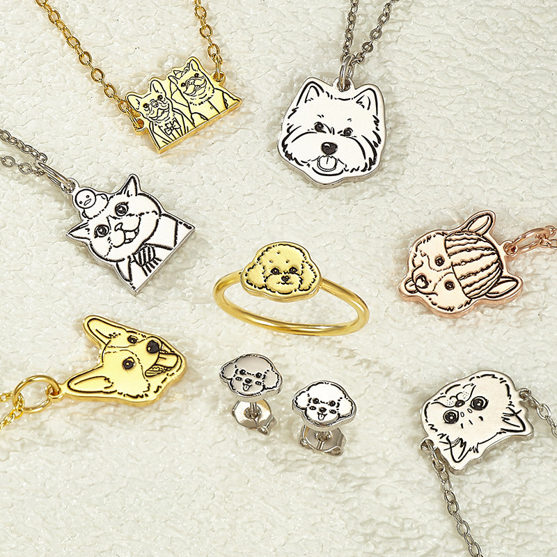 Collection of dog-themed jewelry including necklaces, rings, and earrings on a light background.